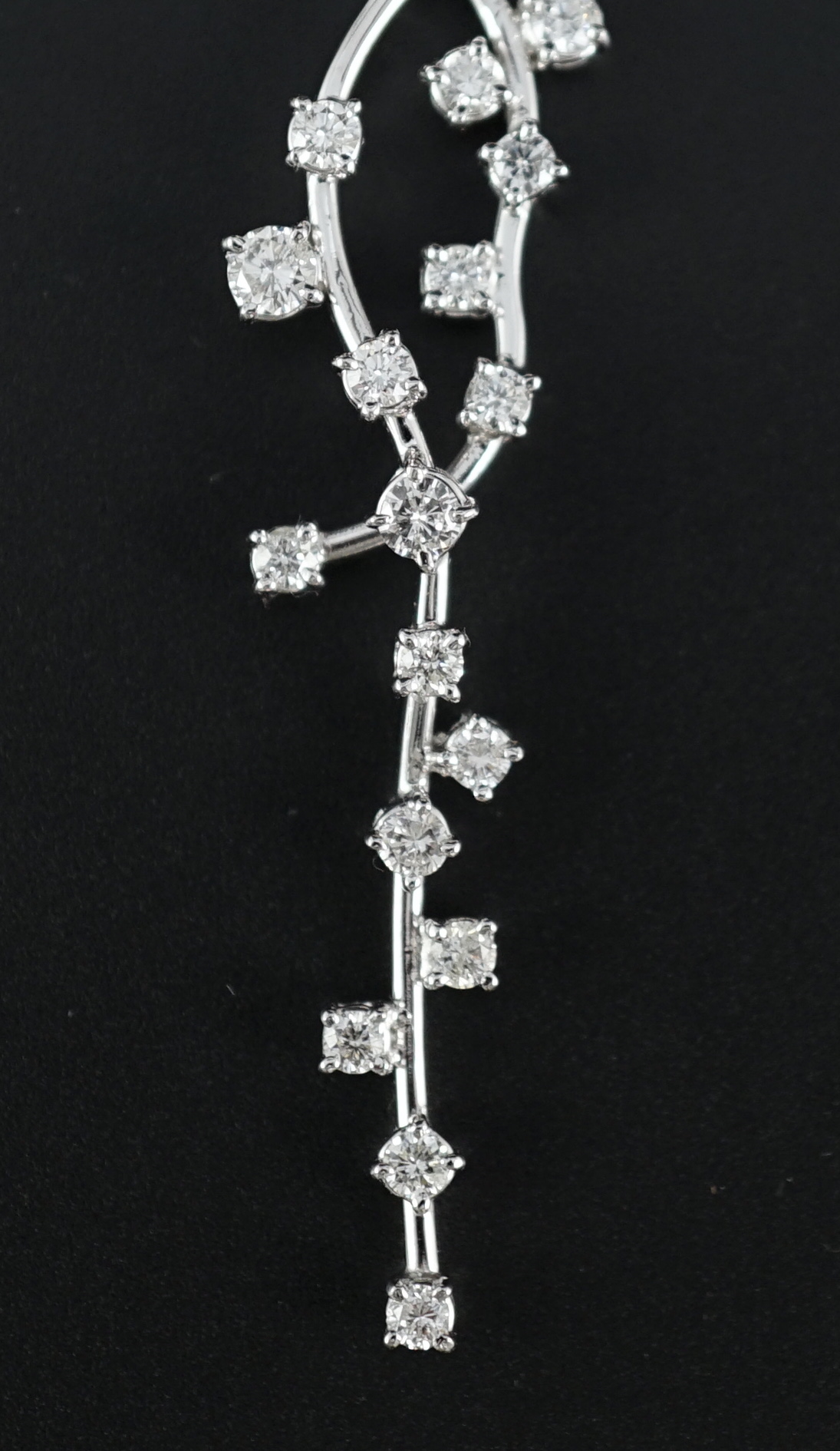 A modern 18k white gold and diamond cluster set necklace